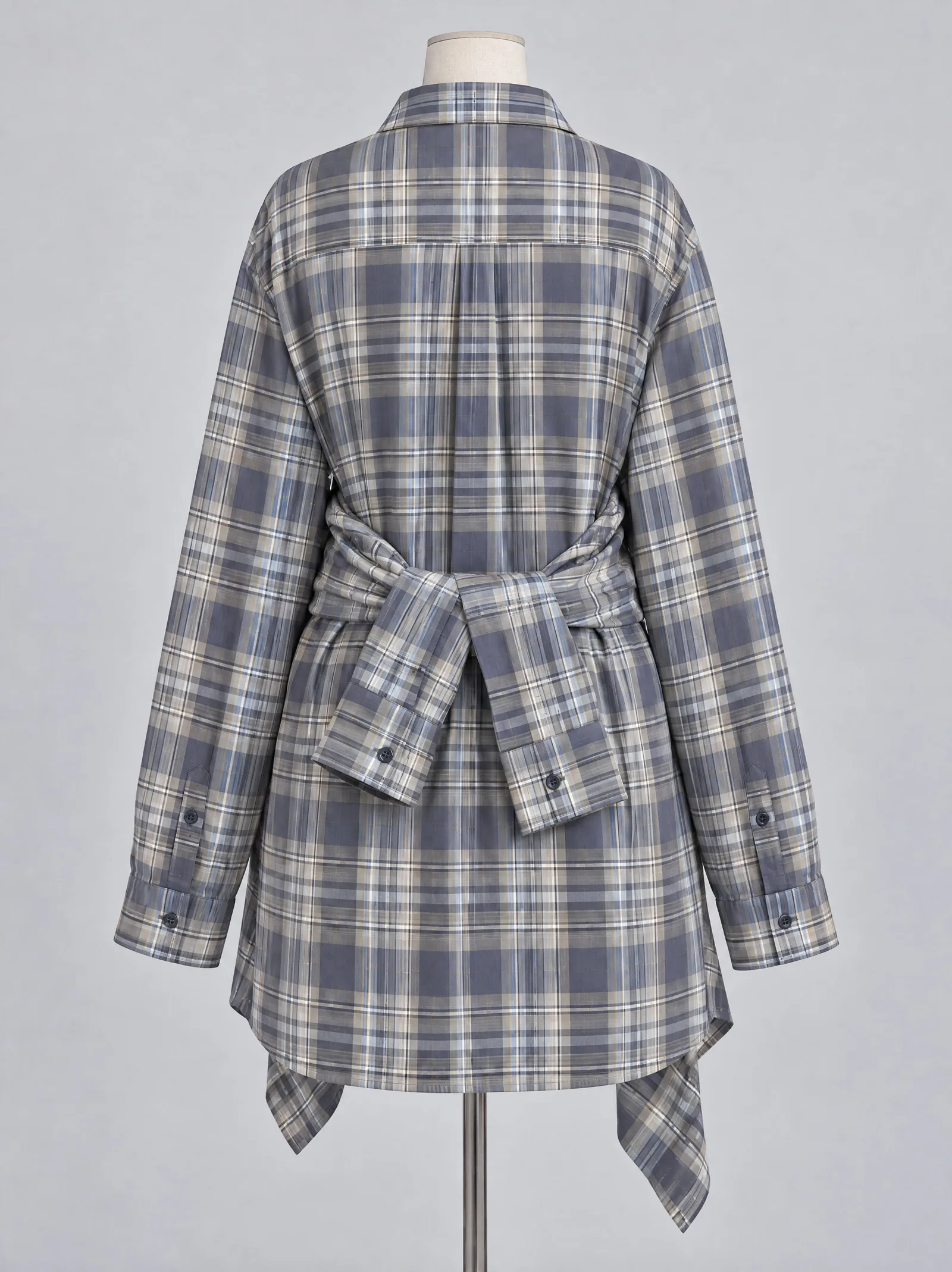 The same shirt dress photographed from the back, showing the yoke, the wrapped sleeves of the tied shirt and the hem